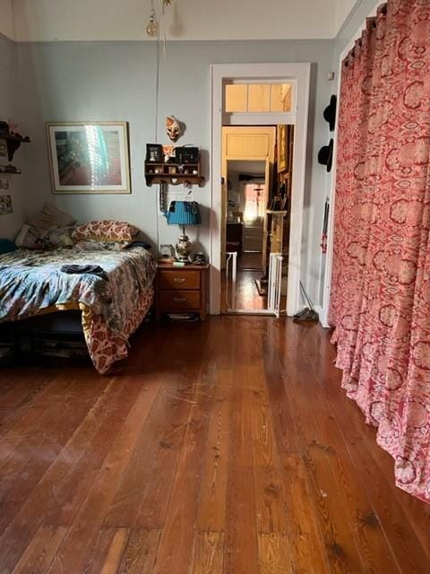 bedroom with dark hardwood / wood-style floors