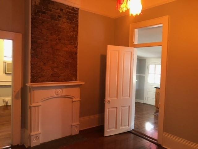 928 Independence St, New Orleans, LA 70117 - interior space with an inviting chandelier, baseboards, and dark wood-style flooring
