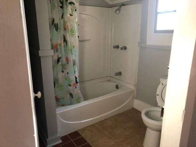 bathroom featuring toilet, shower / tub combo, and tile patterned flooring