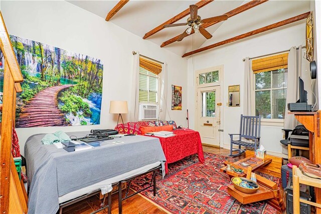 bedroom with hardwood / wood-style floors, ceiling fan, cooling unit, and multiple windows