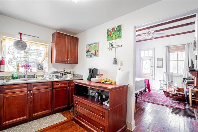 kitchen with dark hardwood / wood-style flooring, ceiling fan, and sink