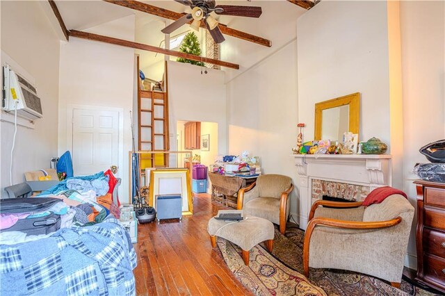 interior space with high vaulted ceiling, a stone fireplace, ceiling fan, beamed ceiling, and wood-type flooring