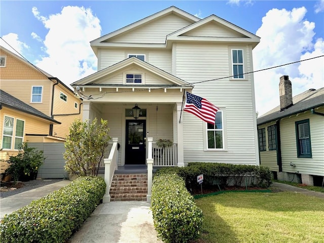 view of front property featuring a porch and a front yard