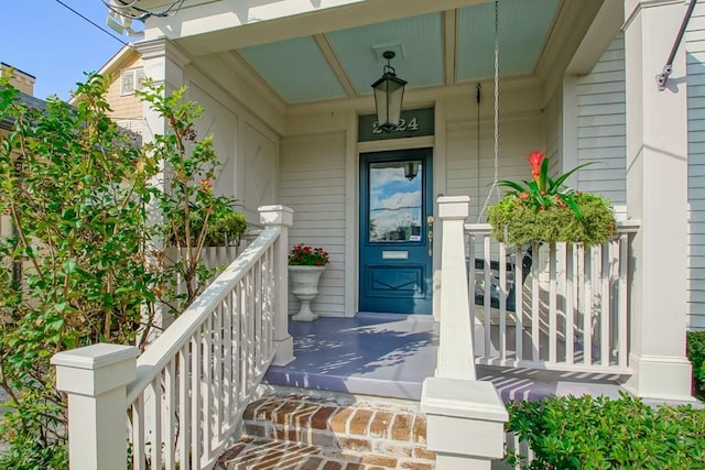 doorway to property featuring covered porch