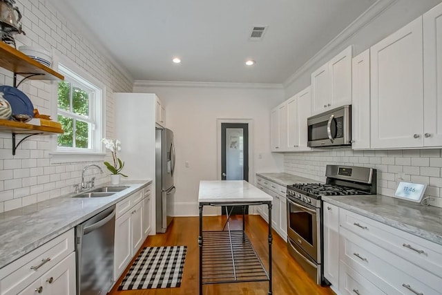 kitchen featuring white cabinetry, light wood-type flooring, appliances with stainless steel finishes, and sink