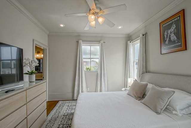 bedroom with ornamental molding, dark hardwood / wood-style flooring, and ceiling fan