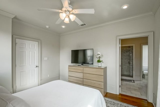 bedroom featuring dark wood-type flooring, ceiling fan, connected bathroom, and ornamental molding