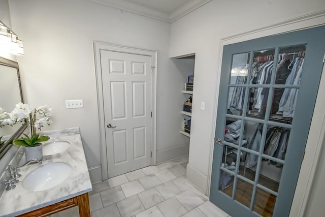 bathroom with ornamental molding and vanity