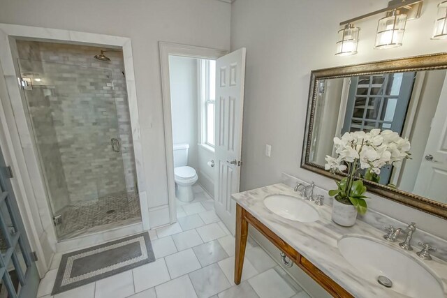 bathroom with walk in shower, vanity, toilet, and tile patterned flooring