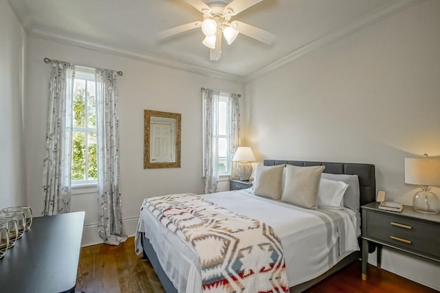 bedroom featuring dark hardwood / wood-style flooring, multiple windows, ceiling fan, and crown molding