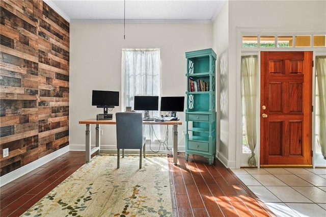 office with hardwood / wood-style floors, wooden walls, and crown molding