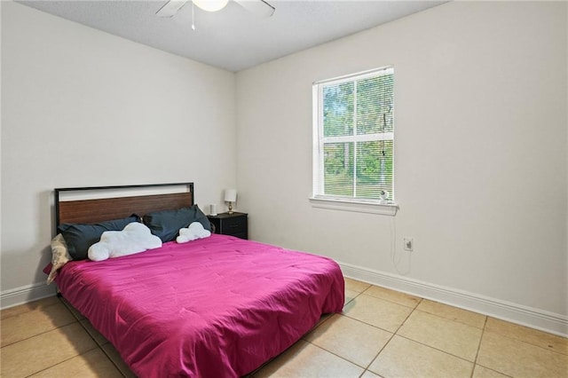 bedroom with ceiling fan and light tile patterned floors