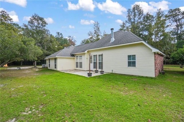 back of house featuring a patio and a yard