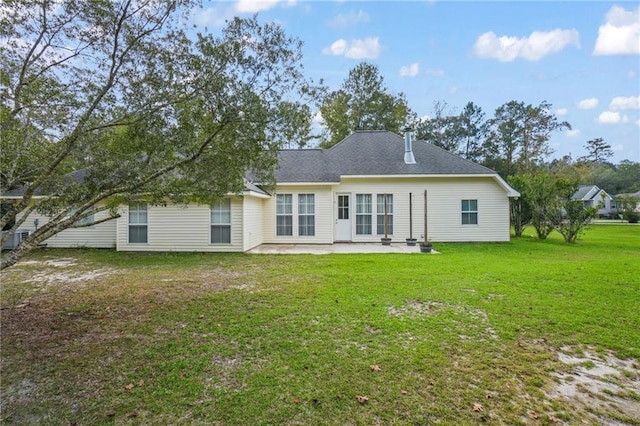 back of property with a patio and a yard