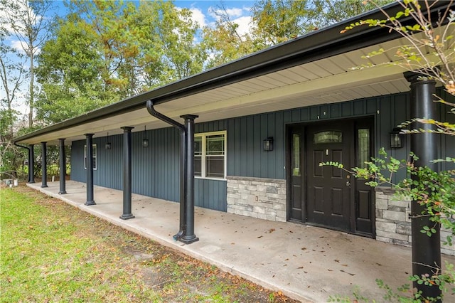 view of exterior entry featuring a porch