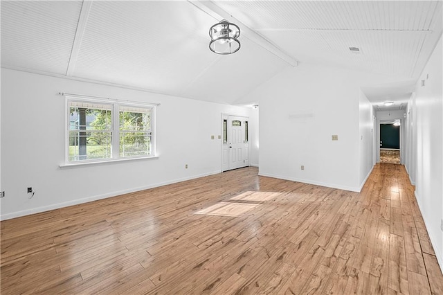 unfurnished living room with light hardwood / wood-style floors and vaulted ceiling with beams