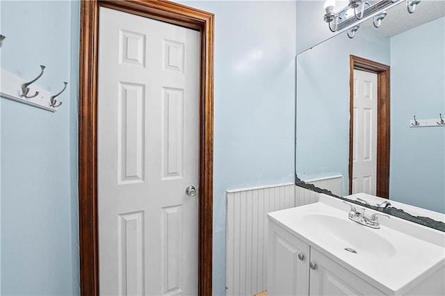 bathroom with vanity and a textured ceiling