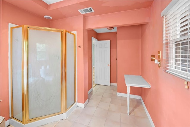 full bathroom featuring a shower stall, baseboards, and tile patterned floors