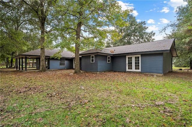 rear view of property with a lawn and french doors