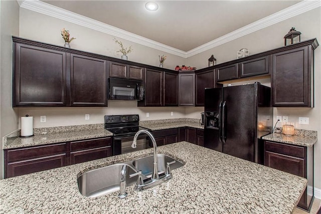 kitchen with black appliances, light stone countertops, and dark brown cabinets