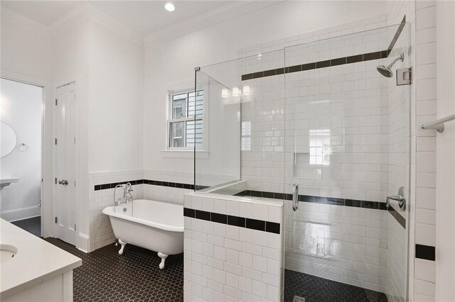 bathroom with tile patterned floors, vanity, shower with separate bathtub, and crown molding