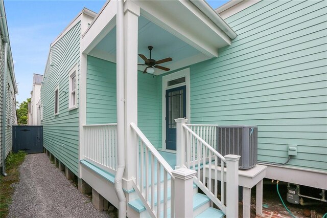 view of exterior entry featuring central AC unit and ceiling fan