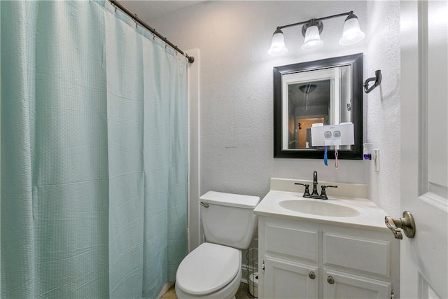 bathroom featuring a shower with curtain, vanity, and toilet