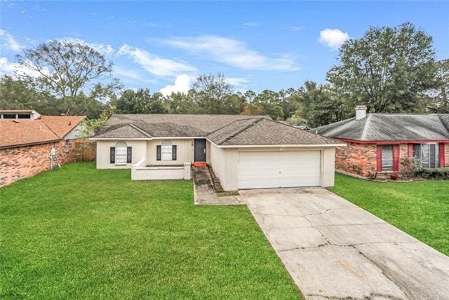 single story home with a front yard and a garage