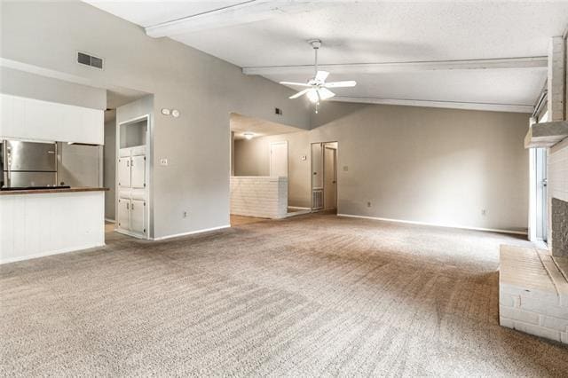 unfurnished living room featuring ceiling fan, carpet floors, vaulted ceiling, and a brick fireplace