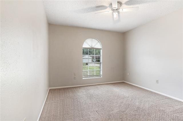 carpeted empty room with a textured ceiling and ceiling fan