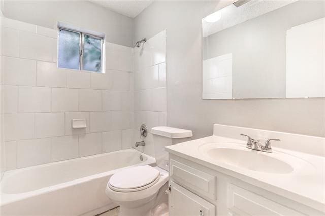 full bathroom featuring vanity, toilet, and tiled shower / bath