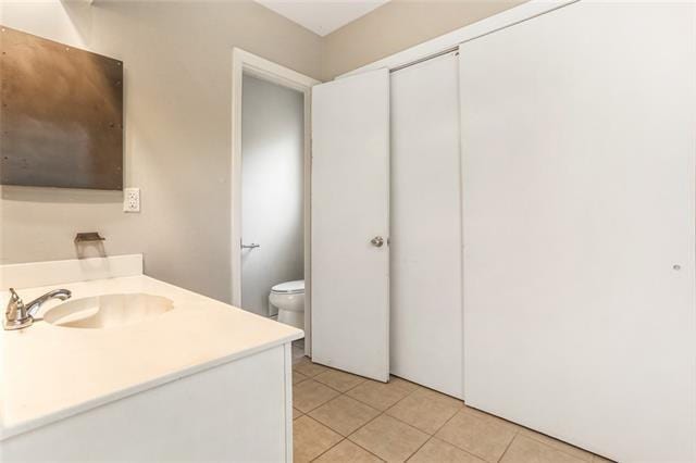 bathroom with tile patterned floors, vanity, and toilet