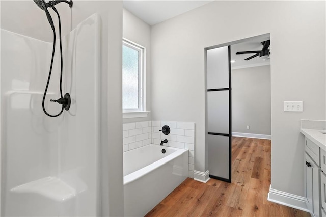 bathroom featuring ceiling fan, vanity, a bathtub, and hardwood / wood-style floors