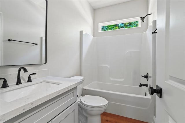 full bathroom featuring vanity, wood-type flooring,  shower combination, and toilet