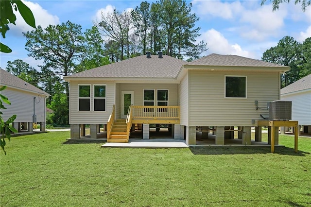 rear view of house featuring a deck, a yard, and central AC unit