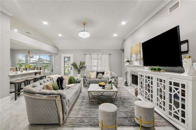 living room with a chandelier and ornamental molding