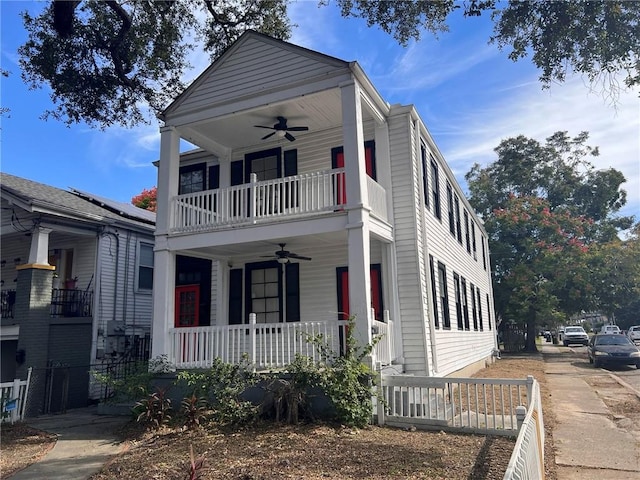 view of front of home with covered porch, ceiling fan, and a balcony