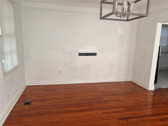 3633 Franklin Ave, New Orleans, LA 70122 - unfurnished dining area with wood-type flooring, ornamental molding, baseboards, and a chandelier
