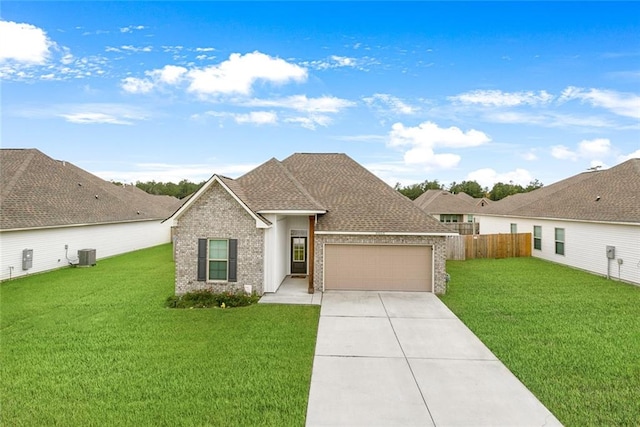 single story home with central air condition unit, a garage, and a front yard