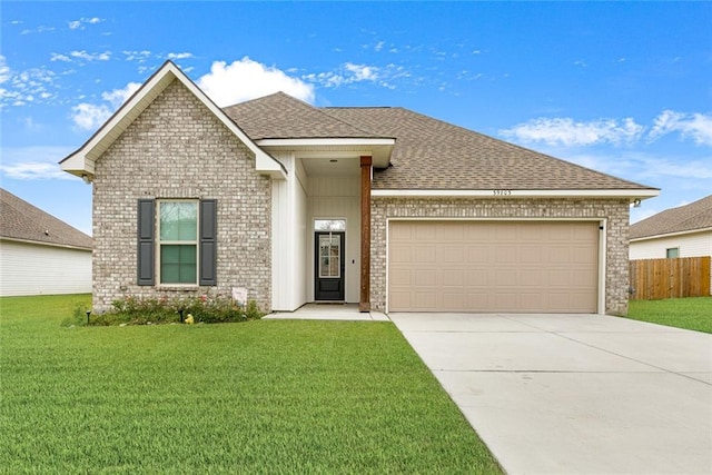 view of front of house featuring a garage and a front yard