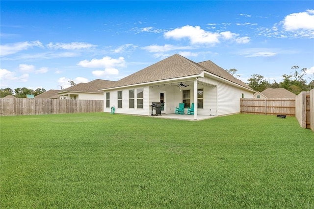 back of property with a patio and a lawn