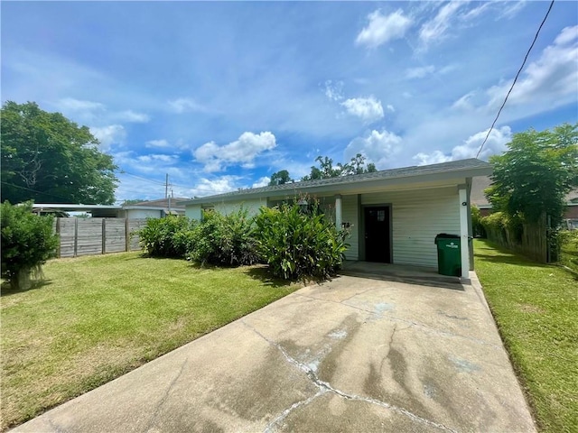 view of front of house with a carport and a front lawn