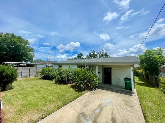 view of front of property with a front yard and a carport