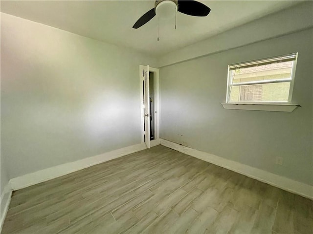 spare room with ceiling fan and light hardwood / wood-style floors