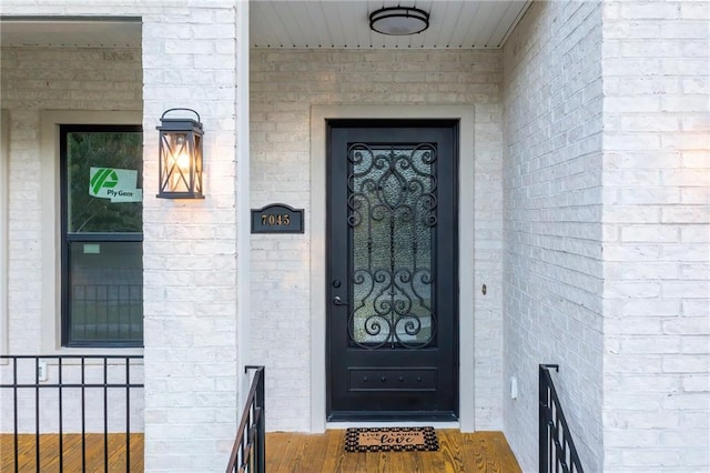 property entrance with brick siding