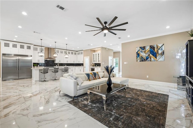 living area with marble finish floor, visible vents, recessed lighting, crown molding, and a ceiling fan