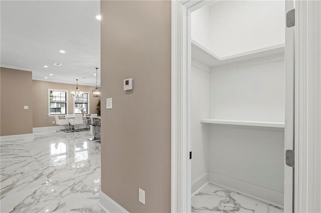 hall featuring an inviting chandelier, baseboards, marble finish floor, and recessed lighting
