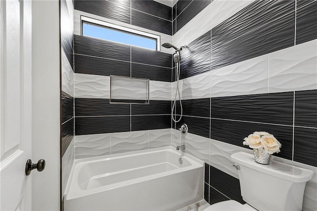 full bathroom with toilet,  shower combination, and tile walls
