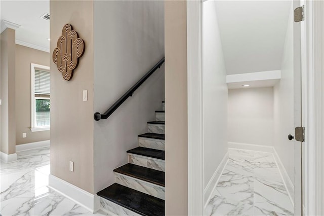 staircase featuring ornamental molding, baseboards, and marble finish floor