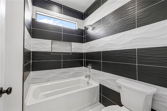 full bathroom with toilet, tile walls, and shower / bathing tub combination